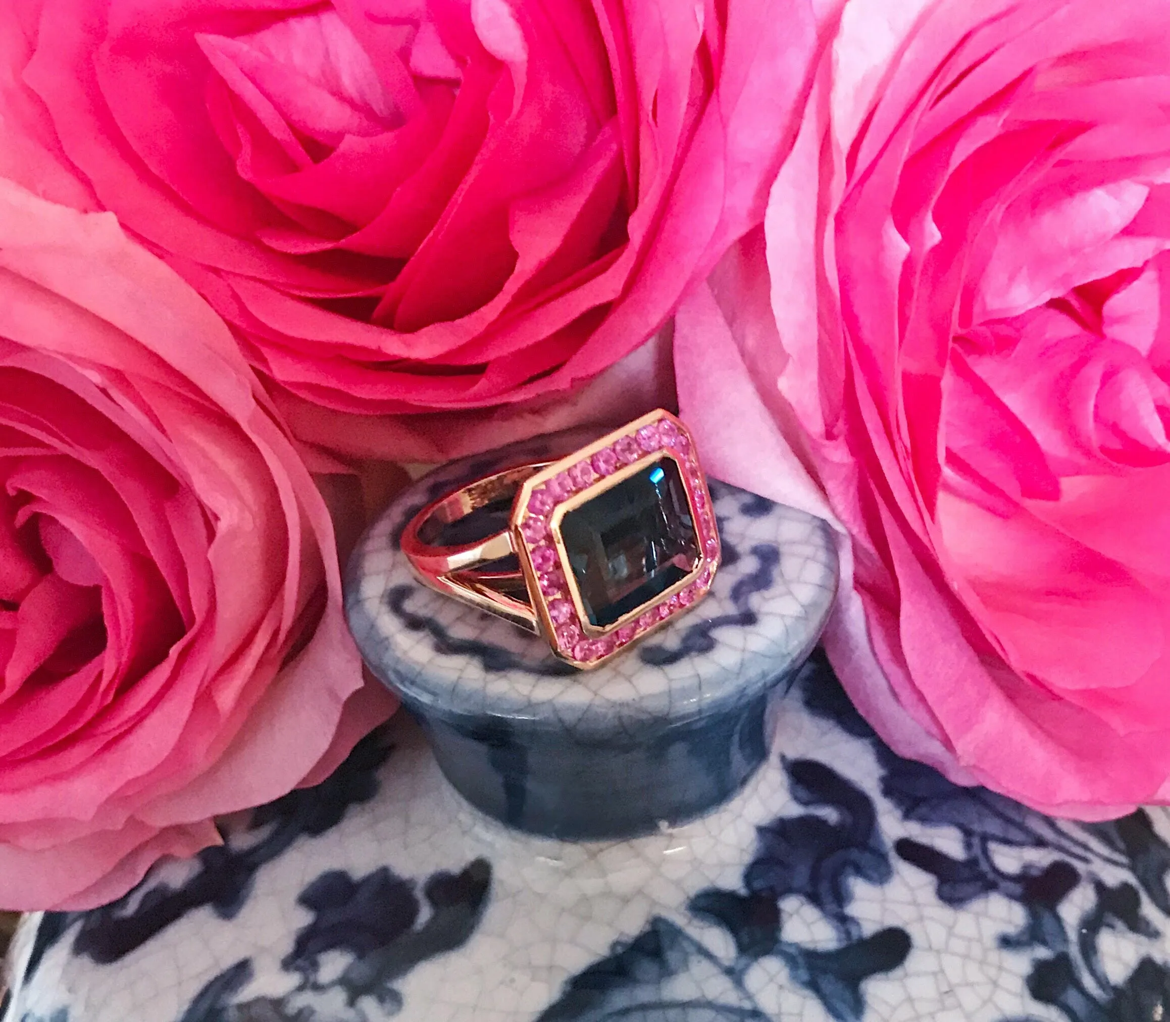 Rose Gold Bezel Set Dark Blue Topaz with Surrounding Pink Sapphire Ring